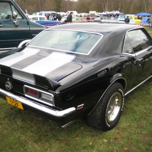 Black with silver racing stripes, 60's Chevy Camaro