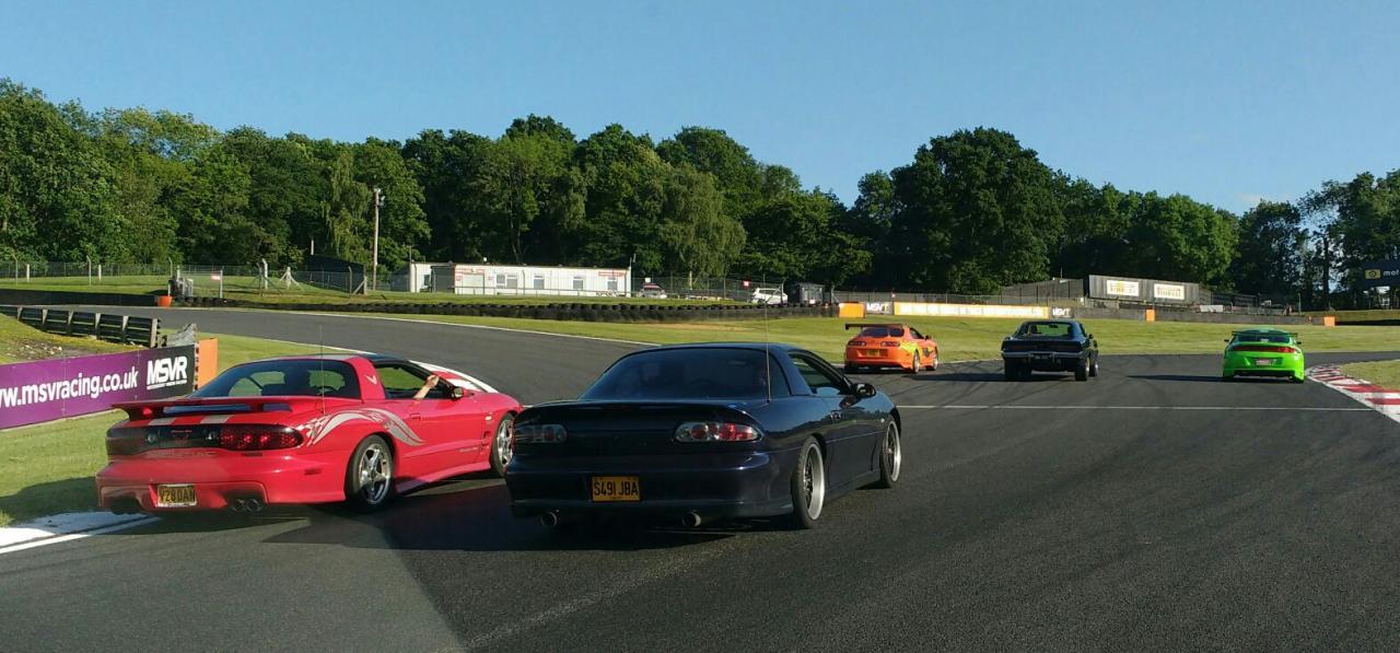 Lined up on the Brandhatch race track behind the fast &amp; furious cars.